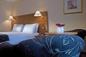 A bed or beds in a room at Hickstead Hotel 