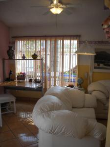 a living room with a white couch and a table at Welcome To Casa OLE Playas de Tijuana 5-Rooms 14-Guests close to Shoping Center & Beach in Tijuana