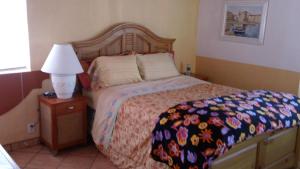 a bedroom with a bed and a lamp on a night stand at Welcome To Casa OLE Playas de Tijuana 5-Rooms 14-Guests close to Shoping Center & Beach in Tijuana