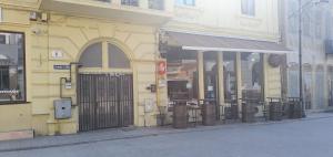 a yellow building with a gate on a street at ZIG ZAG apartment 6 - Old Town Constanta in Constanţa