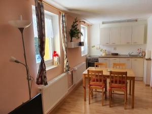 a kitchen with a table and chairs in a room at Ubytování U Šustrů in Horní Maršov