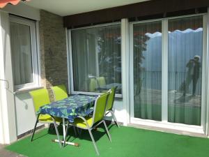 a table and two chairs on a porch with a table at Casa Franceschini in Locarno