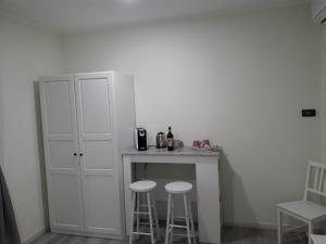 a small kitchen with two stools and a counter at CASA LIBERTY in Mandello del Lario