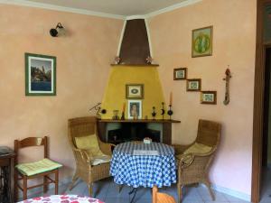 a dining room with a table and chairs at Nonna Lelletta in Lanusei