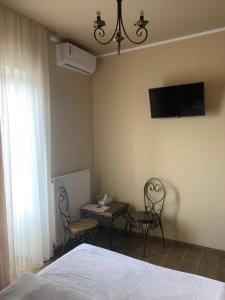 1 dormitorio con 1 cama, 2 sillas y mesa en Готель Ангел на Великій Кільцевій, en Kiev