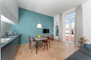 a kitchen and dining room with a table and chairs at Hotel Piazza Bellini & Apartments in Naples