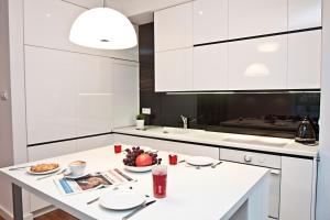 a kitchen with a white counter top and a white sink at Platinum Towers Country 2 Country in Warsaw