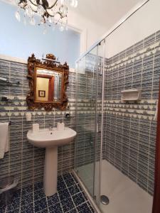 a bathroom with a sink and a shower and a mirror at La Luna sul Porto in Santa Margherita Ligure
