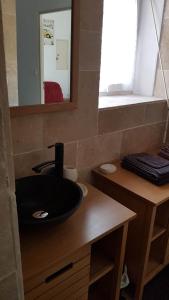 a bathroom with a black sink and a mirror at Chez Laurence in Santenay +37 photos