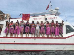 a group of women in dresses on a boat at Bike&Boat Argentario Hotel in Porto Santo Stefano