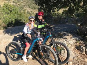 a man and woman sitting on bikes on a trail at Bike&Boat Argentario Hotel in Porto Santo Stefano