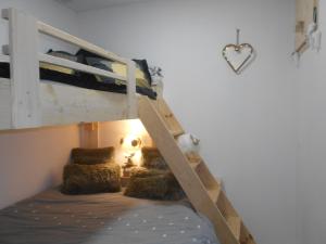 a bedroom with a bunk bed with pillows at Charmant T2 en DUPLEX ARAVET113 in La Salle Les Alpes