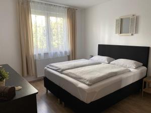 a bed in a bedroom with a large window at Ferienwohnung Geidel in der Altstadt Nordhausen in Nordhausen