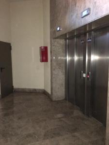 an empty room with two metal elevators in a building at Estudio San Felipe in Cádiz