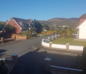 a view of a street with houses and a fence at Highfields Self Contained Studio in Newry