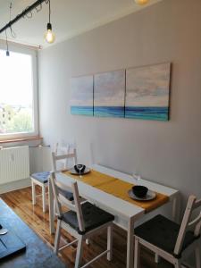 a dining room with a table and chairs at Panoráma apartman in Tapolca