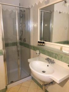 a bathroom with a sink and a shower at Amalfitano Apartments in Amalfi