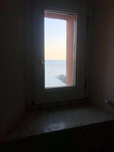 a window in a room with a view of the ocean at Amalfitano Apartments in Amalfi