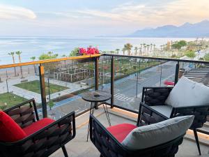 a balcony with chairs and a table and the ocean at ONLY ONE Suites & Residences in Antalya