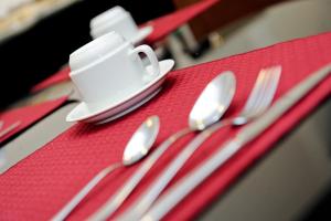 
a table topped with plates and cups filled with food at Faria Lima Flat Service in Sao Jose do Rio Preto

