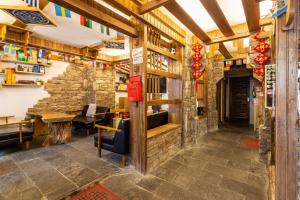 a restaurant with a stone wall and a table at Destination Youth Hostel in Zhangjiajie