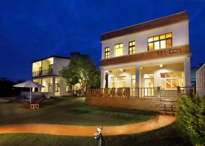 a large white house at night with a yard at Ecotourism skim month B & B in Xiaoliuqiu