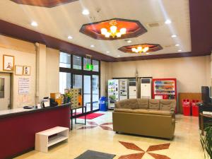 a waiting room with a couch in a store at 宇和パークホテル in Seiyo