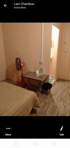 a small room with a table and a bed at Natural bungalows in Kampong Cham