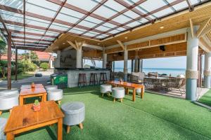 an outdoor kitchen and dining area with a view of the ocean at Chaba Cabana Beach Resort in Chaweng