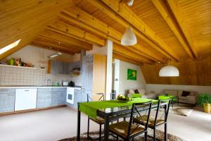a kitchen with a green table and chairs at Business Homes - Das Apartment Hotel in Lauchheim