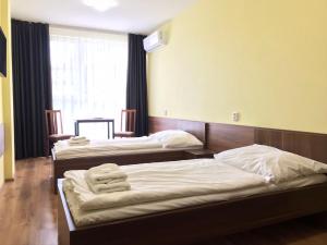 Postel nebo postele na pokoji v ubytování Hotel Aréna