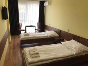 Postel nebo postele na pokoji v ubytování Hotel Aréna