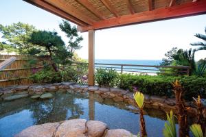 
a garden area with a pool of water and trees at Imaiso in Kawazu

