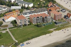 an aerial view of a resort with a beach and buildings at Meeresblick-Storchennest-Haus-1-WE-13 in Hohwacht