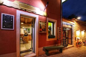 a restaurant with a bench in front of a building at Dida Boža House in Vodice