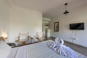 a bedroom with a white bed with a bow on it at myPatong Social Hostel in Patong Beach