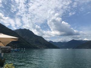 a view of a lake with mountains in the background at Appartamento Nelly - per 4 persone - Caray Park - Sale Marasino - Lago d'Iseo in Marone