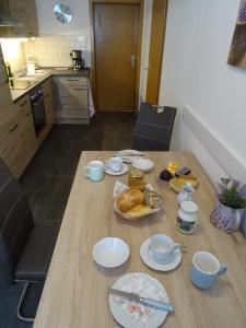 a table with plates of food on it in a kitchen at Ferienwohnung Bäckerei Förster in Bad Schandau +4 photos