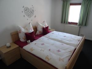 a bedroom with a large bed with white sheets and pillows at Ferienwohnung Bäckerei Förster in Bad Schandau
