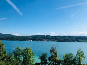 a view of a lake with a boat in the water at Villa Adrienne in Velden am Wörthersee