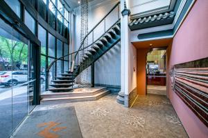 a lobby of a building with a spiral staircase at Jinmao Hotel Xi'an Downtown ( Bell & Drum Tower) in Xi'an