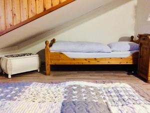 a bedroom with a wooden bed with blue pillows at Ferienwohnung Boller II in Marktredwitz