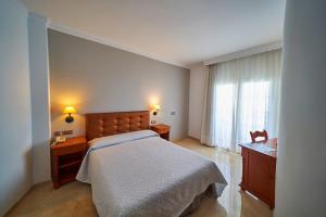 a bedroom with a large bed and a window at Hotel Bajamar Centro in Nerja