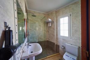 a bathroom with a sink and a shower and a toilet at Hotel Bajamar Centro in Nerja