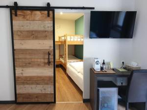 a sliding barn door in a room with a bedroom at Pension Sonnenheim Rooms&Apartments in Gmünd in Kärnten