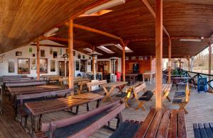 a restaurant with wooden benches and tables in a building at Hotel Panska Licha in Brno