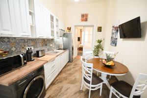 a kitchen with a small table and a microwave at Casa ABA in Sibiu