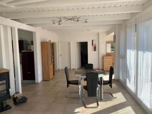 a dining room with a table and chairs at Bungalow in Werder am Glindower See in Werder