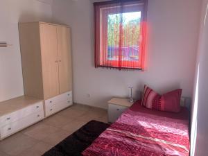 a bedroom with a bed and a window at Bungalow in Werder am Glindower See in Werder