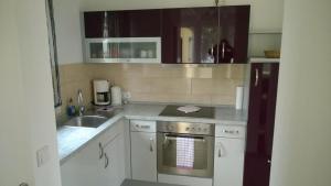a kitchen with a sink and a stove top oven at Bungalow in Werder am Glindower See in Werder +4 photos